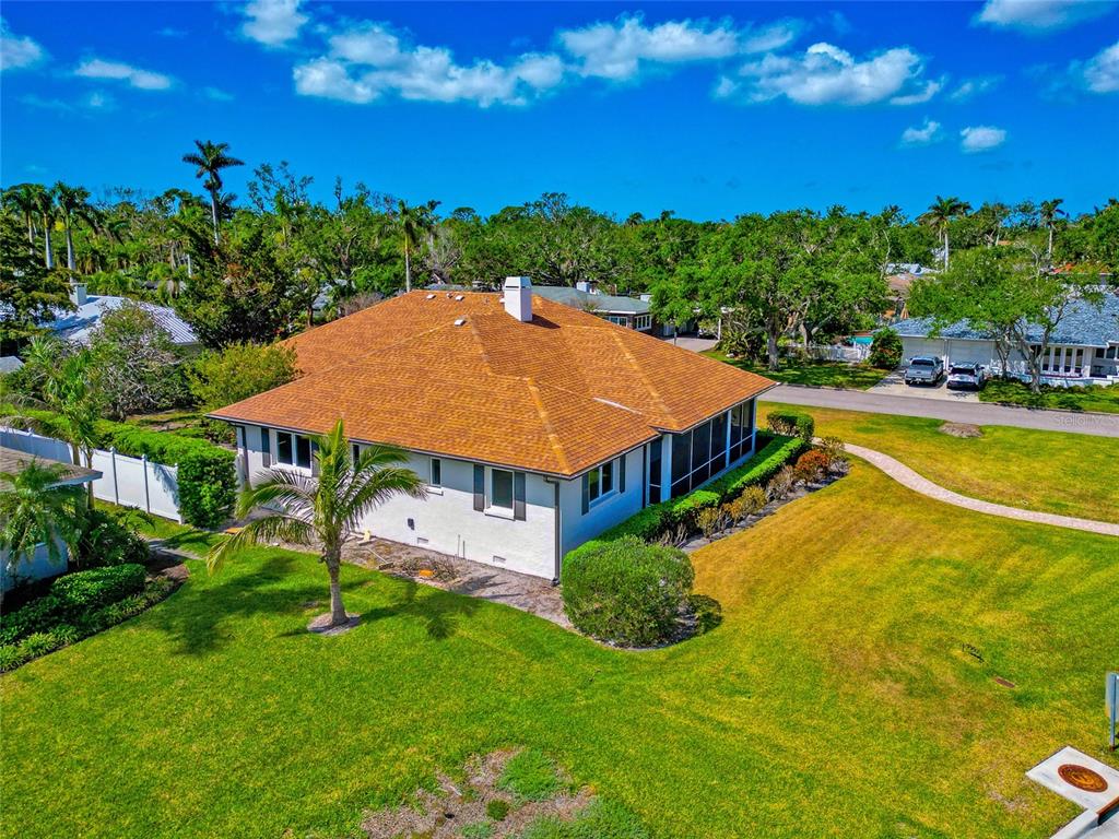 2305 Riverview Boulevard Bradenton, FL 34205 - Photo 10 of 71 a view of a swimming pool with lawn chairs and potted plants