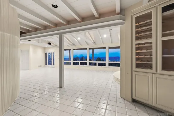 a view of an empty room with a fireplace and a window