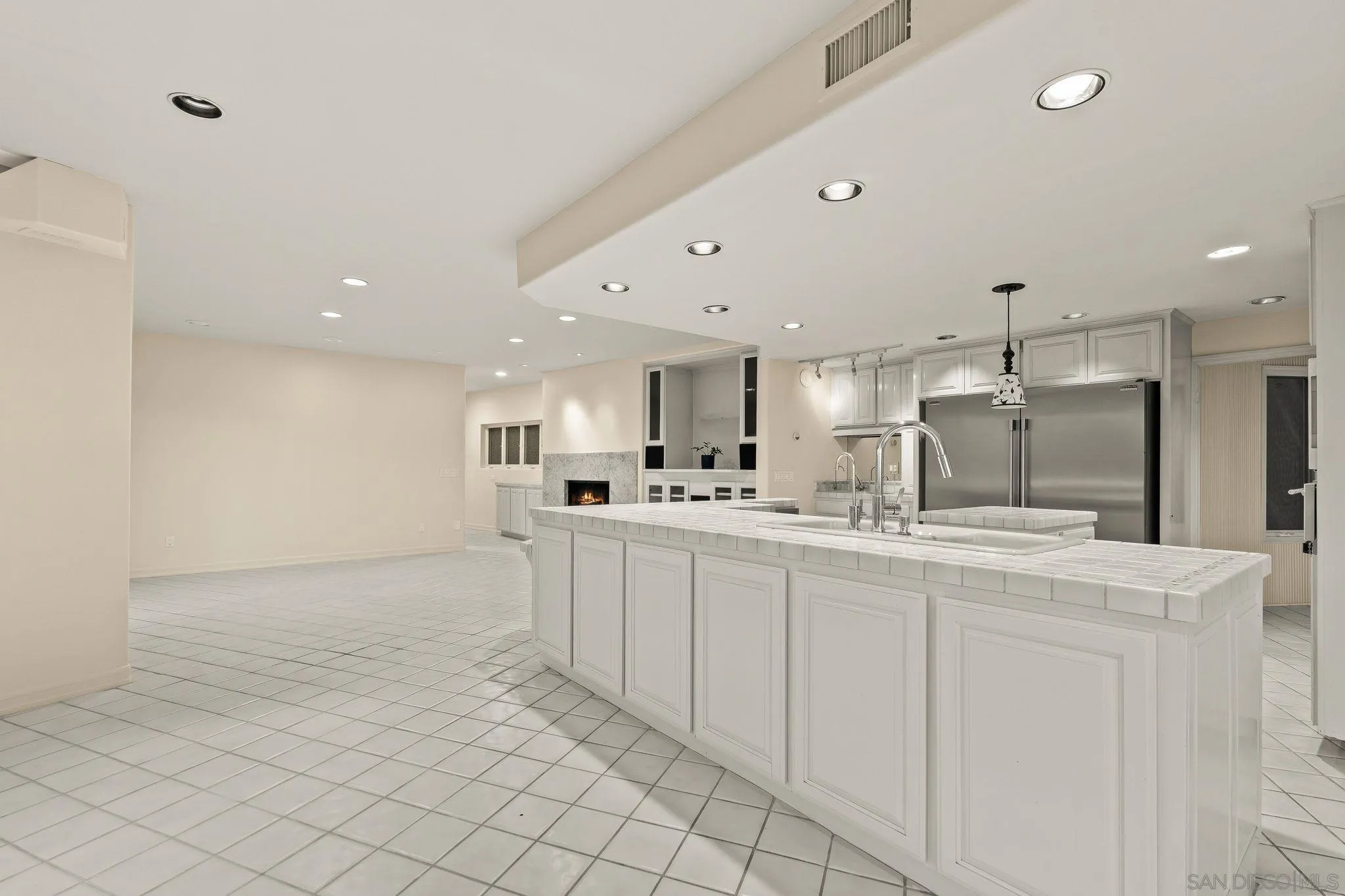 10595 Russell Road La Mesa, CA 91941 - Photo 18 of 40 a large white kitchen with a sink and dishwasher