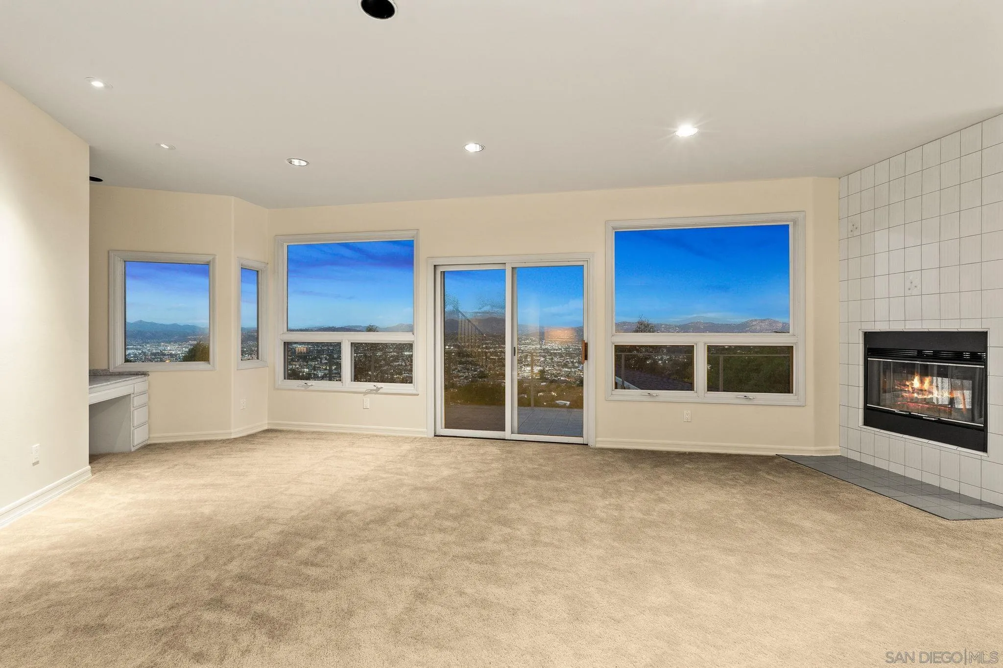 10595 Russell Road La Mesa, CA 91941 - Photo 24 of 40 a view of an empty room with a fireplace and a window