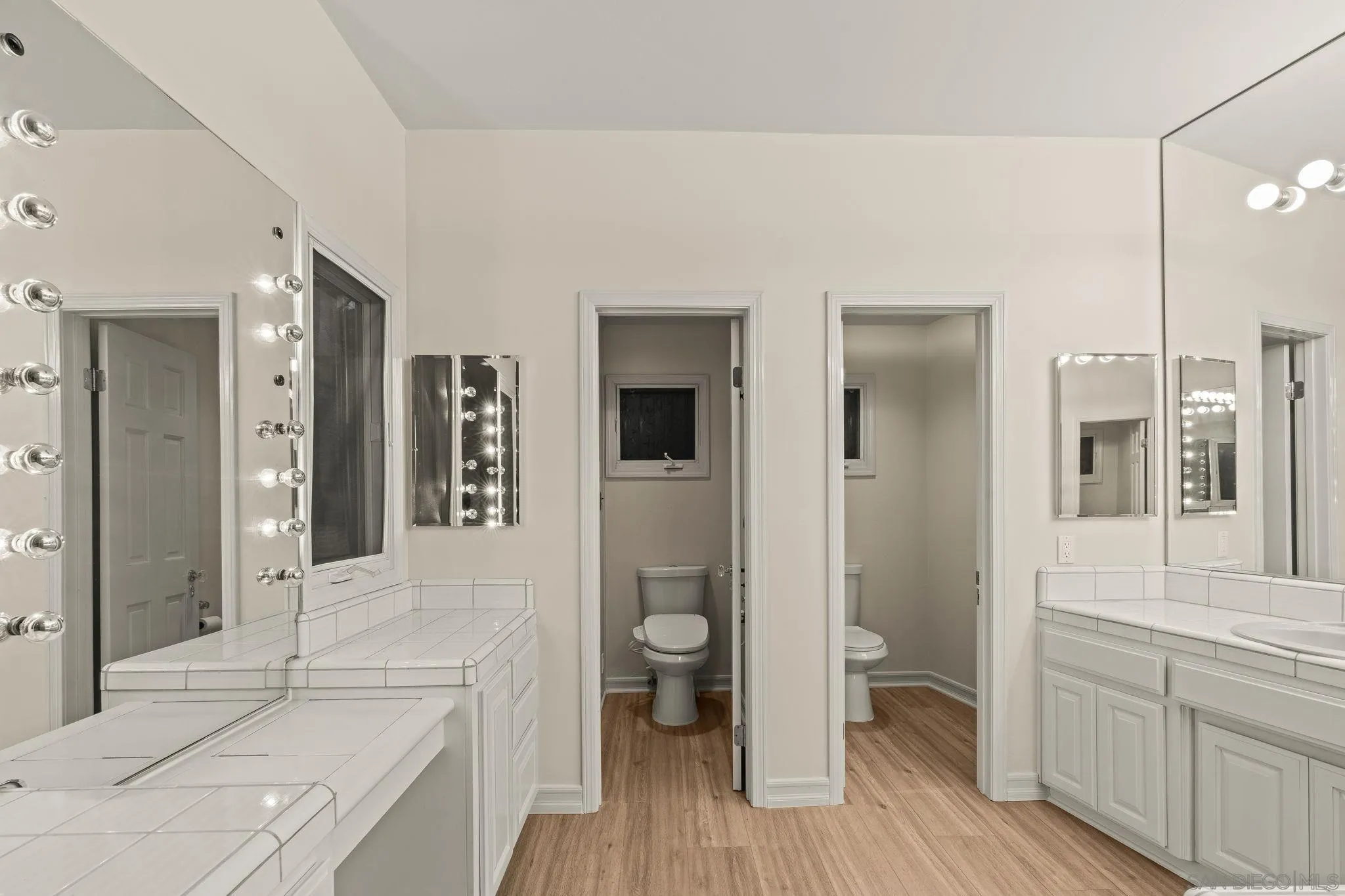 10595 Russell Road La Mesa, CA 91941 - Photo 29 of 40 a bathroom with a sink and mirror with toilet
