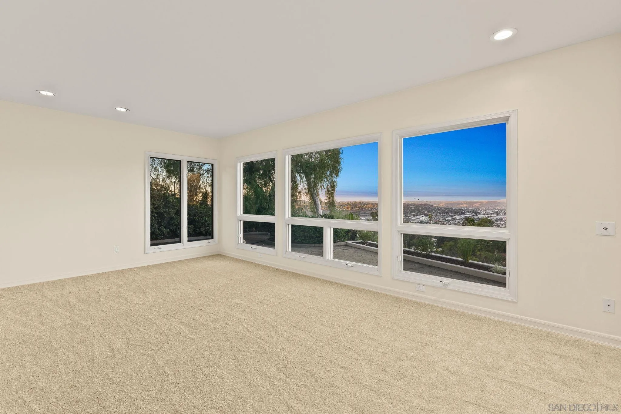 10595 Russell Road La Mesa, CA 91941 - Photo 36 of 40 a view of an empty room with wooden floor and windows