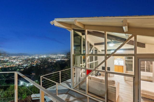 a large white kitchen with a sink and dishwasher