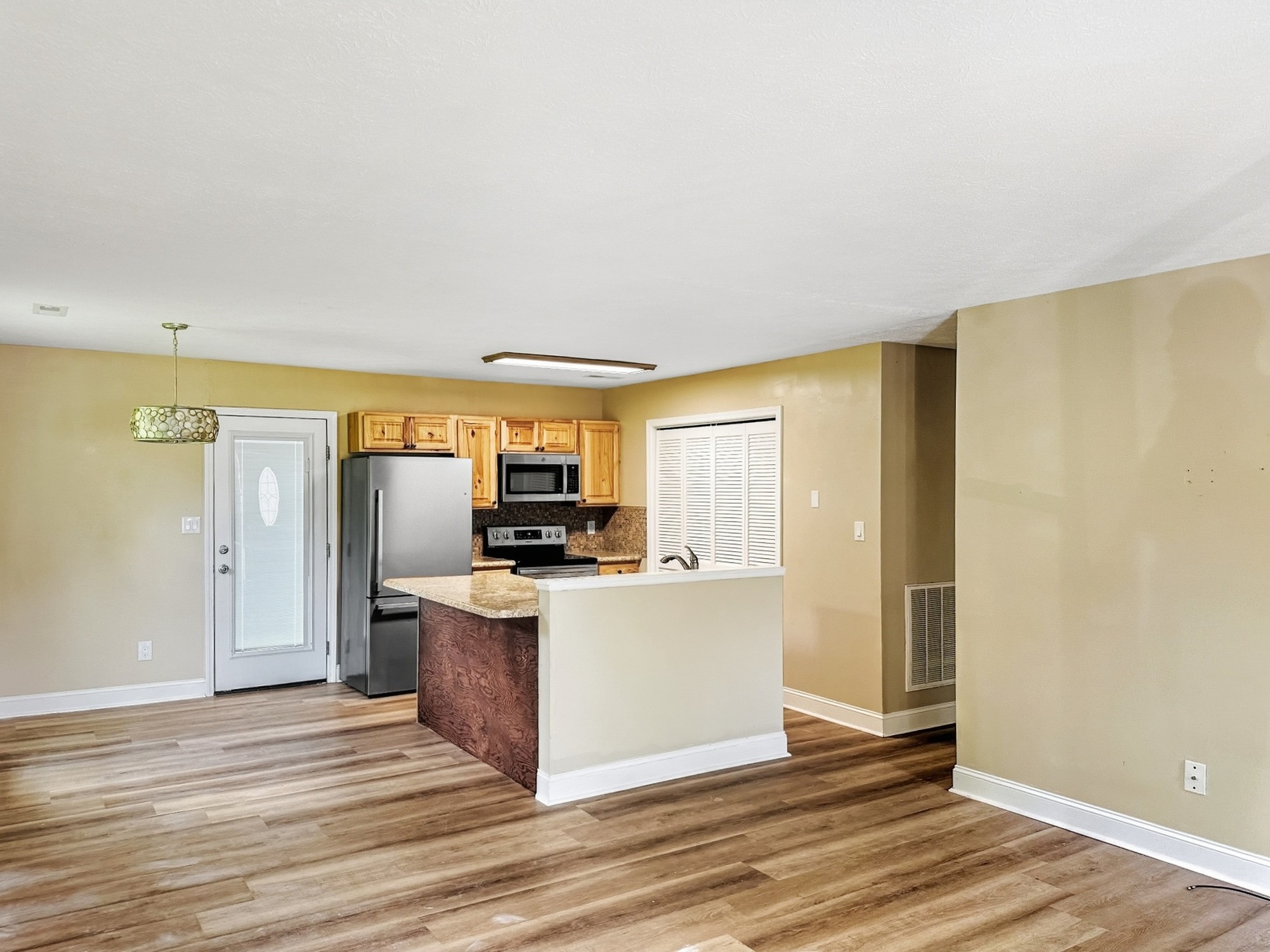 586 Foxfield Road Hopkinsville, KY 42240 - Photo 10 of 16 a view of a kitchen with a sink refrigerator and wooden floor