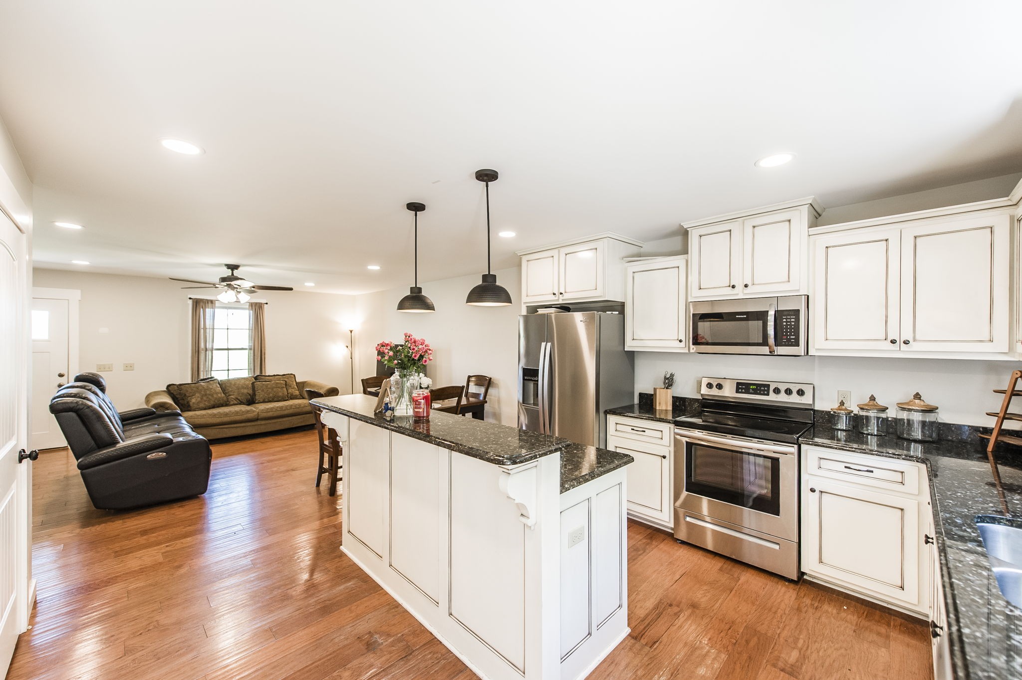 742 Kirbytown Road Lafayette, TN 37083 - Photo 11 of 34 a kitchen with stainless steel appliances kitchen island granite countertop a stove and a refrigerator