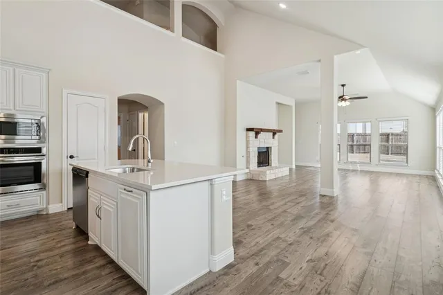 a kitchen with stainless steel appliances granite countertop a stove and a refrigerator