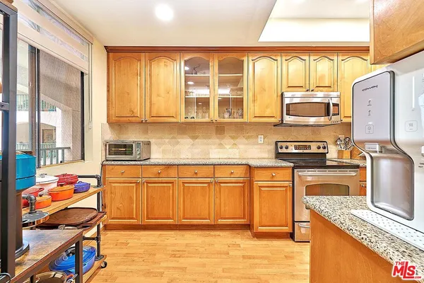 a kitchen with stainless steel appliances granite countertop a stove and a sink