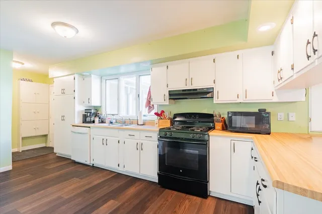 a kitchen with stainless steel appliances granite countertop a stove a sink and a refrigerator