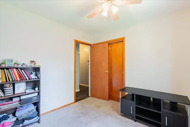 a view of an empty room with closet and a window