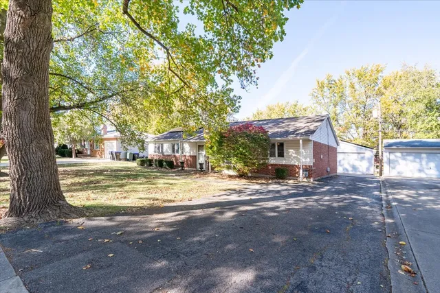 a view of a large trees in front of a house