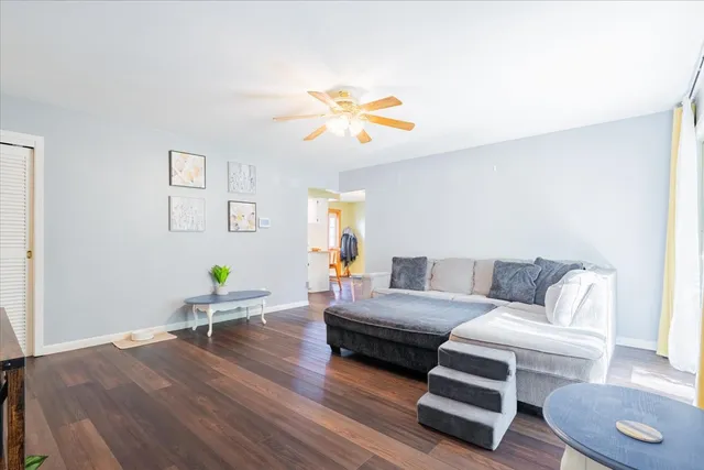 a living room with furniture and a wooden floor