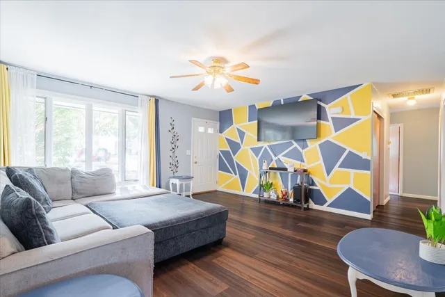a living room with furniture and wooden floor