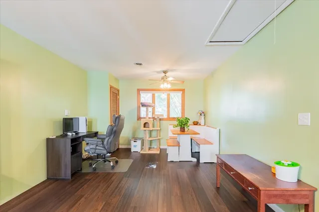 a view of a workspace with furniture and a window