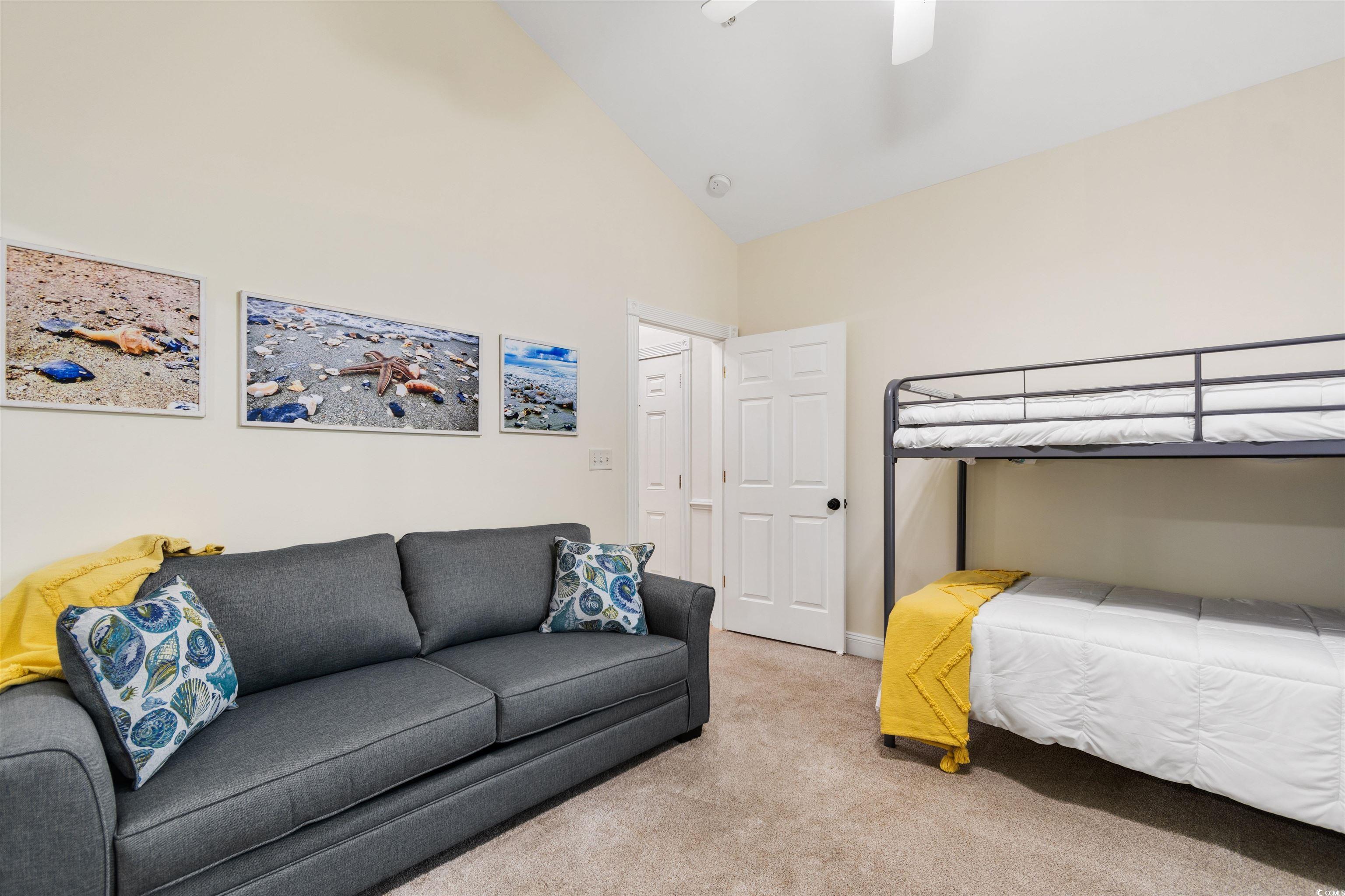 4843 Luster Leaf Circle, Unit 402 Myrtle Beach, SC 29577 - Photo 11 of 33 Bedroom with carpet flooring, ceiling fan, and high vaulted ceiling