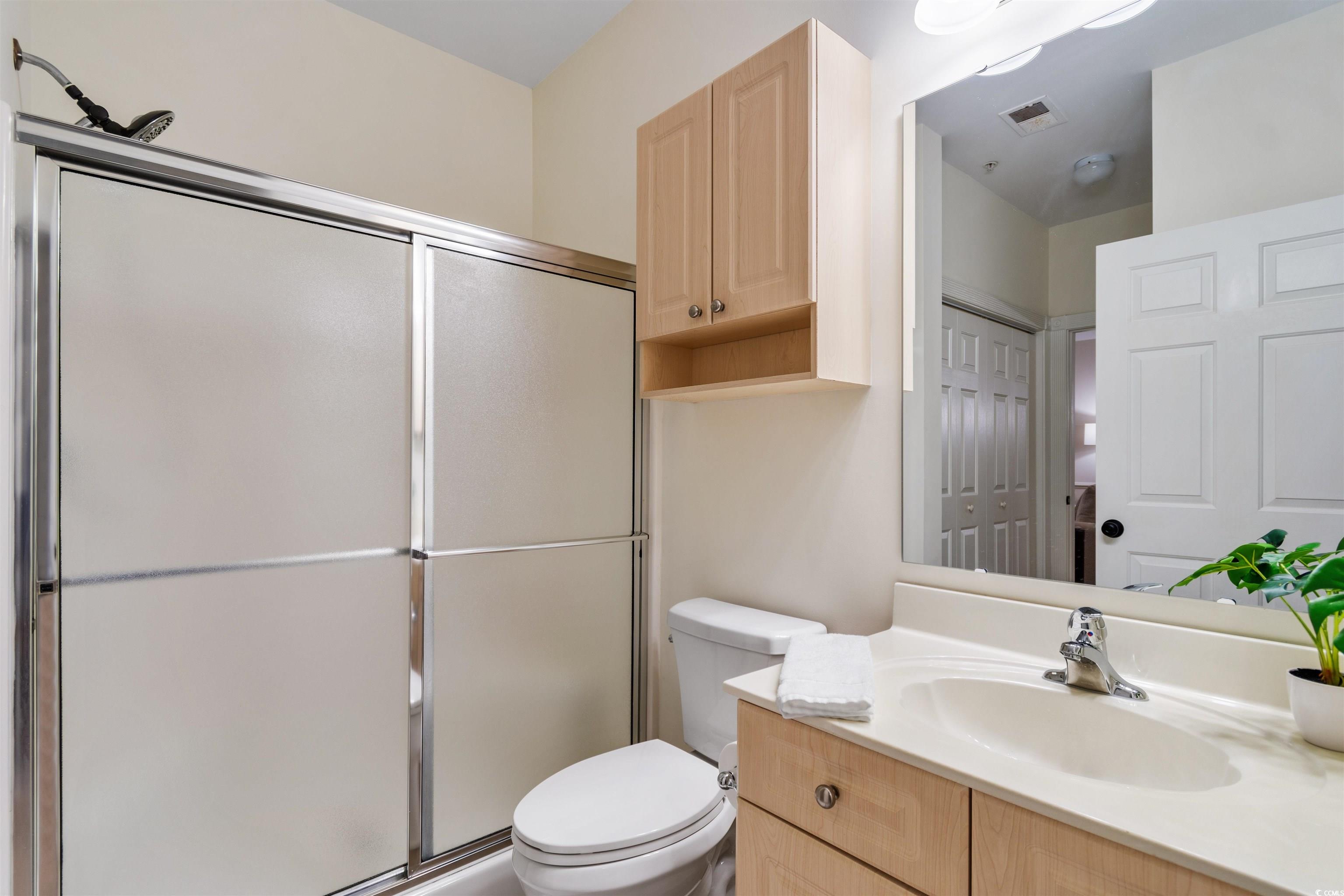 4843 Luster Leaf Circle, Unit 402 Myrtle Beach, SC 29577 - Photo 13 of 33 Bathroom featuring vanity and a stall shower