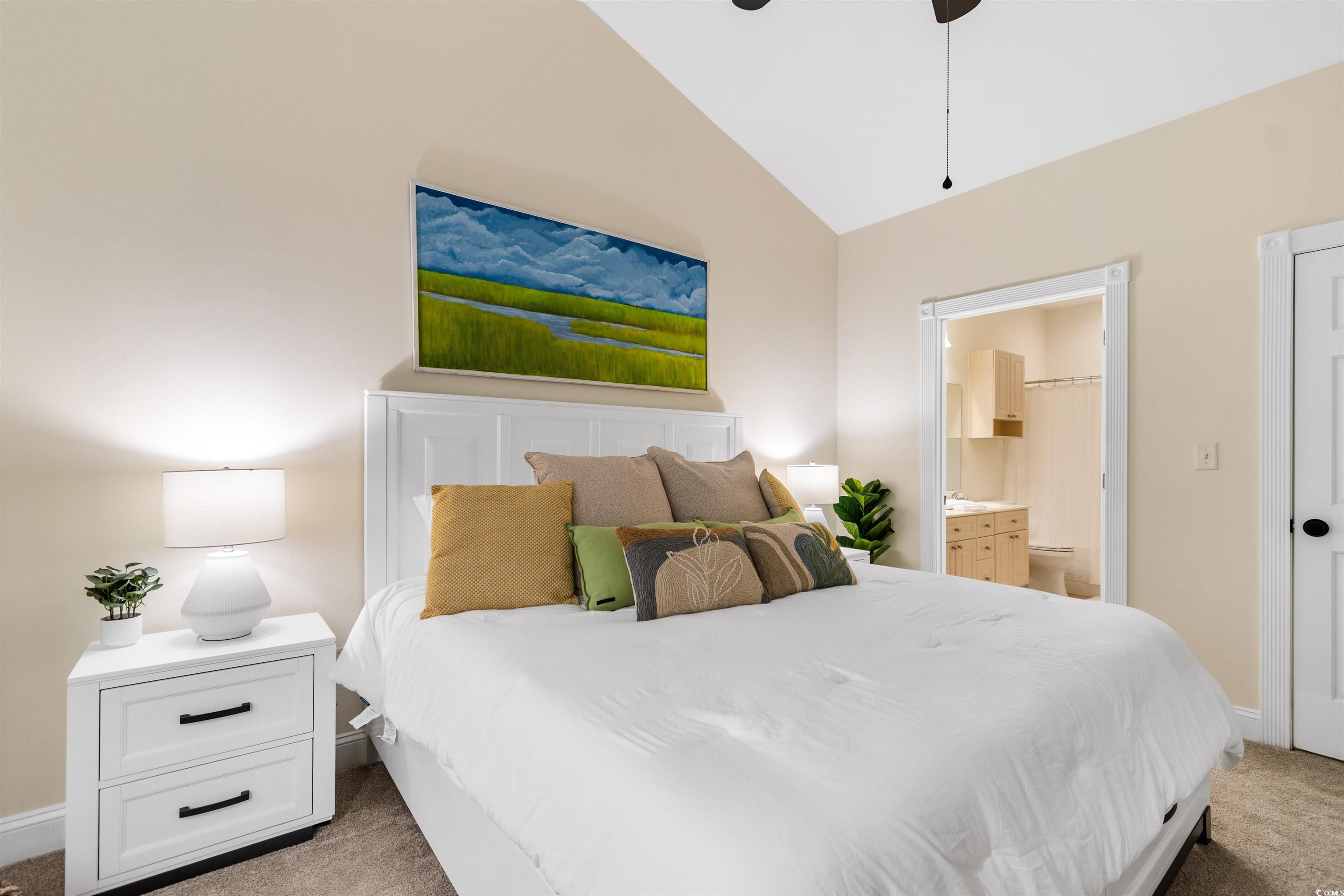 4843 Luster Leaf Circle, Unit 402 Myrtle Beach, SC 29577 - Photo 15 of 33 Bedroom with light colored carpet, ensuite bath, lofted ceiling, and ceiling fan