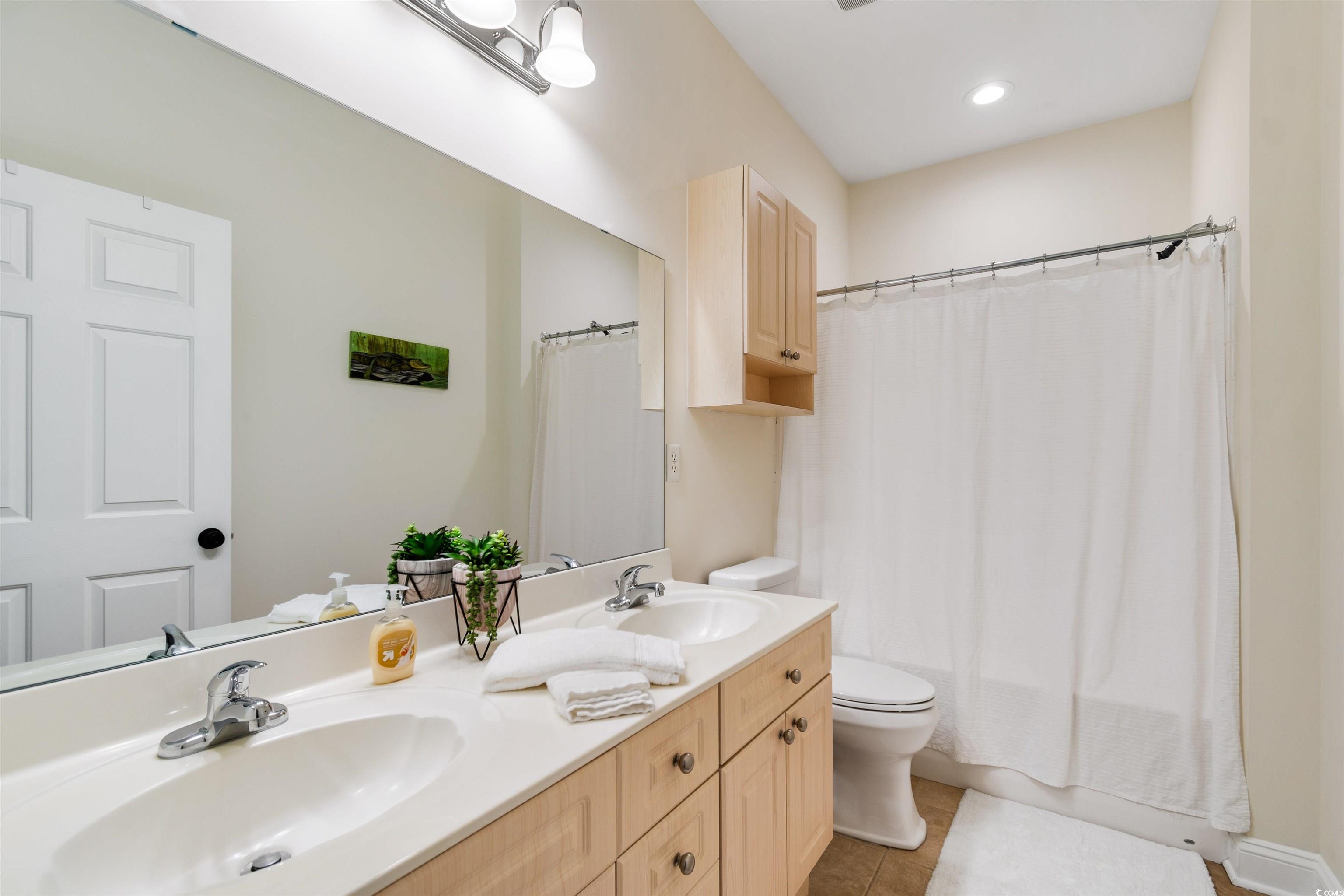 4843 Luster Leaf Circle, Unit 402 Myrtle Beach, SC 29577 - Photo 20 of 33 Full bath featuring shower / tub combo with curtain, double vanity, light tile patterned flooring, and recessed lighting