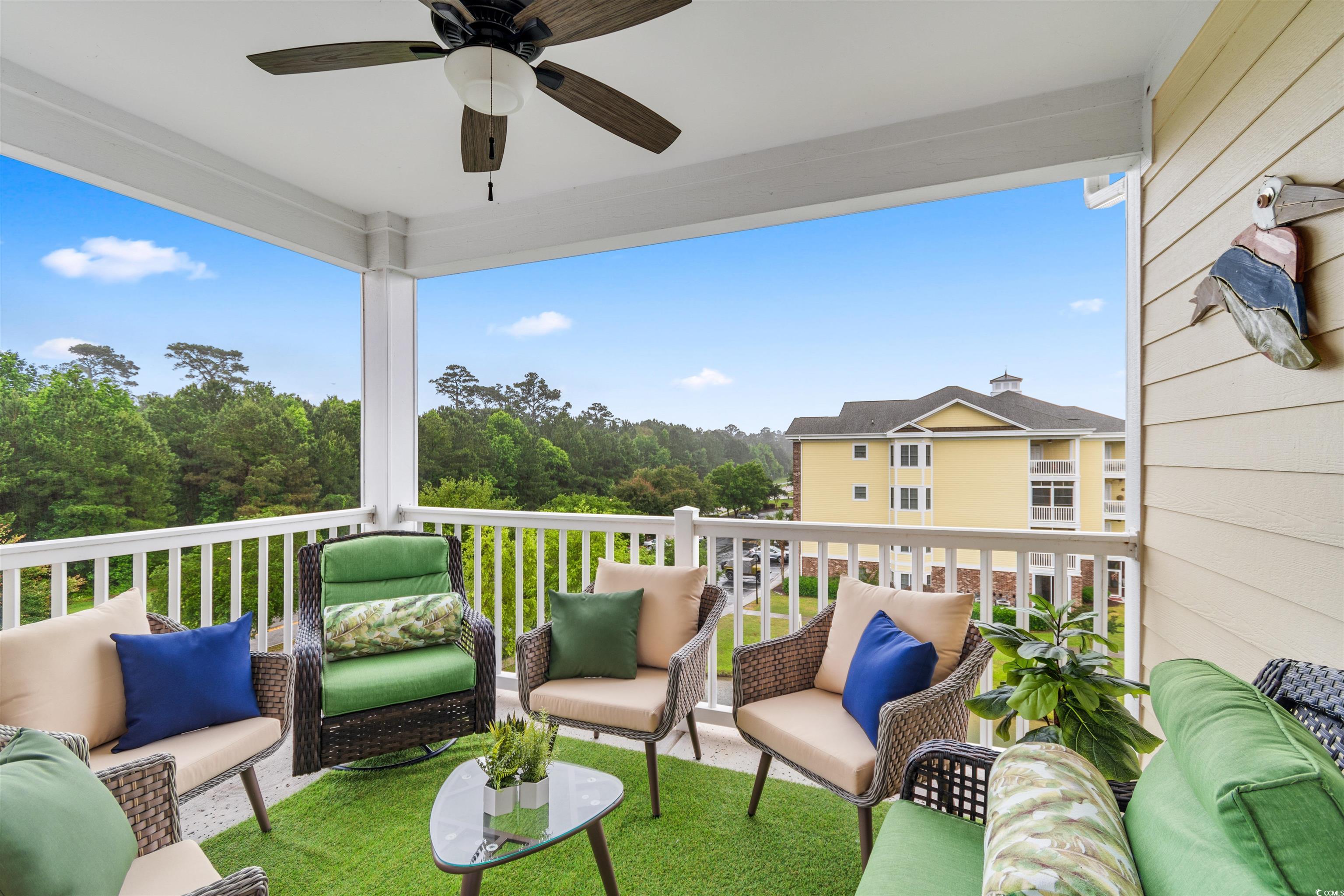 4843 Luster Leaf Circle, Unit 402 Myrtle Beach, SC 29577 - Photo 23 of 33 Balcony featuring an outdoor living space, ceiling fan, and a sunroom