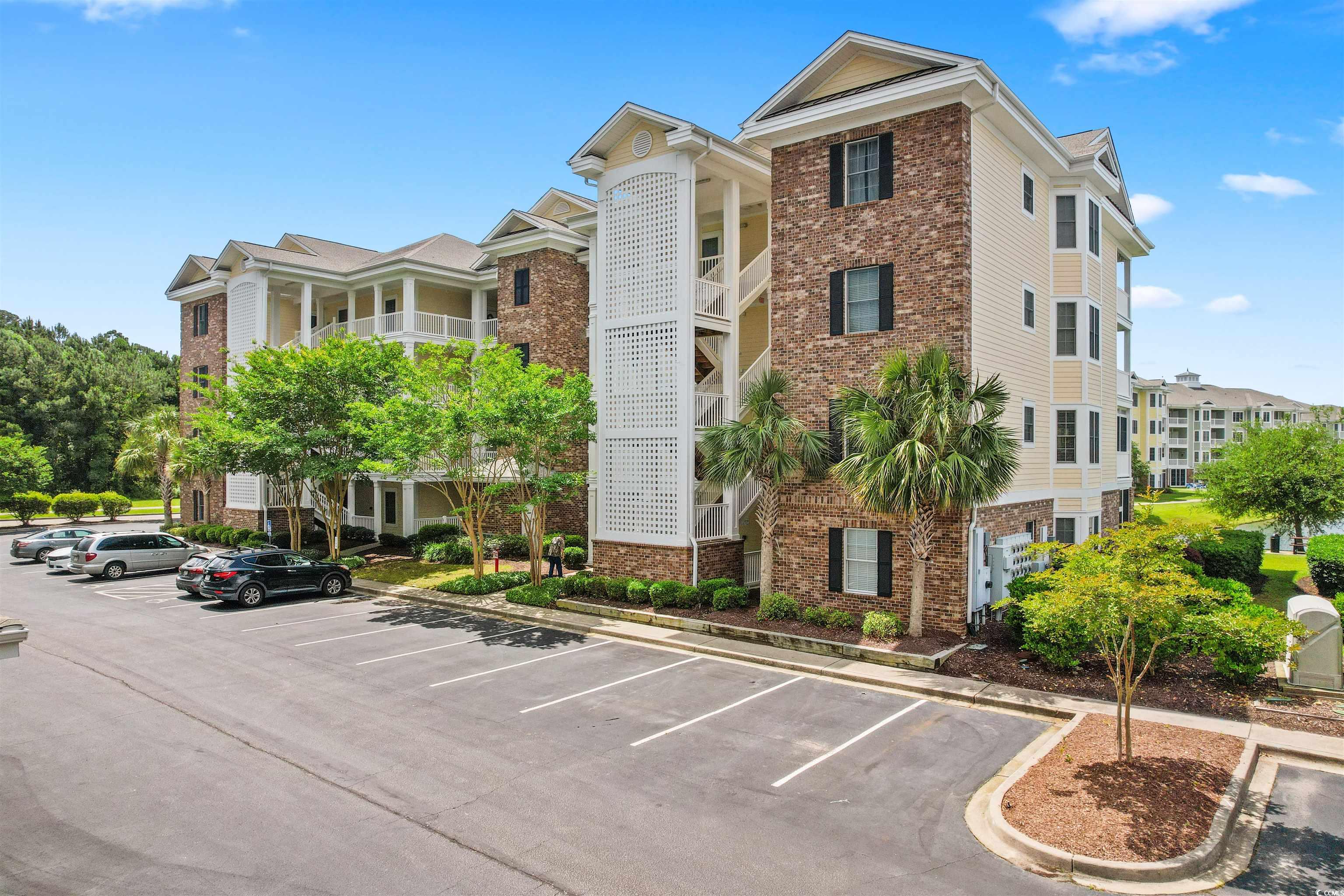 4843 Luster Leaf Circle, Unit 402 Myrtle Beach, SC 29577 - Photo 25 of 33 View of building exterior featuring uncovered parking