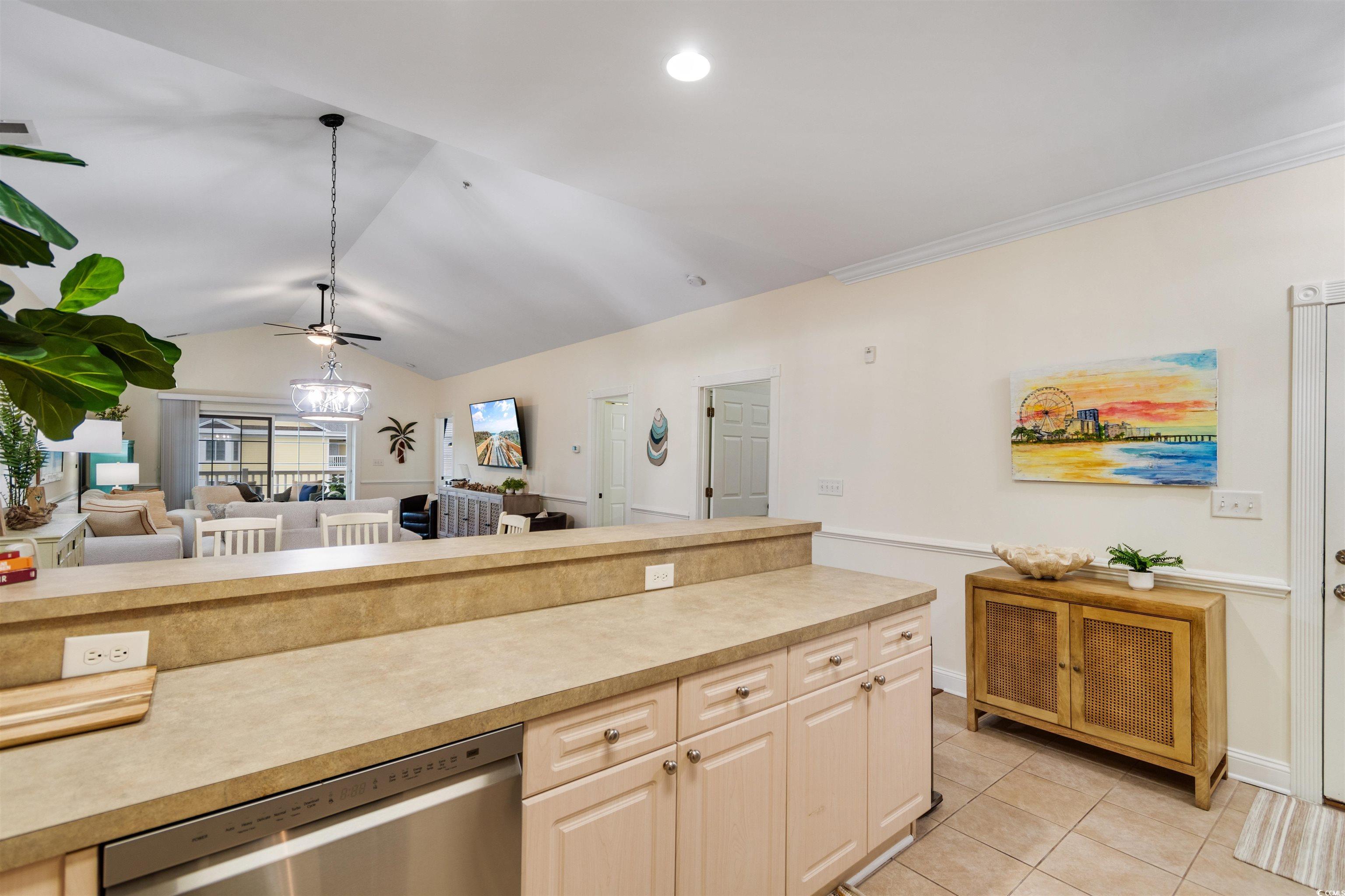 4843 Luster Leaf Circle, Unit 402 Myrtle Beach, SC 29577 - Photo 32 of 33 Kitchen with light countertops, stainless steel dishwasher, open floor plan, light tile patterned flooring, and vaulted ceiling