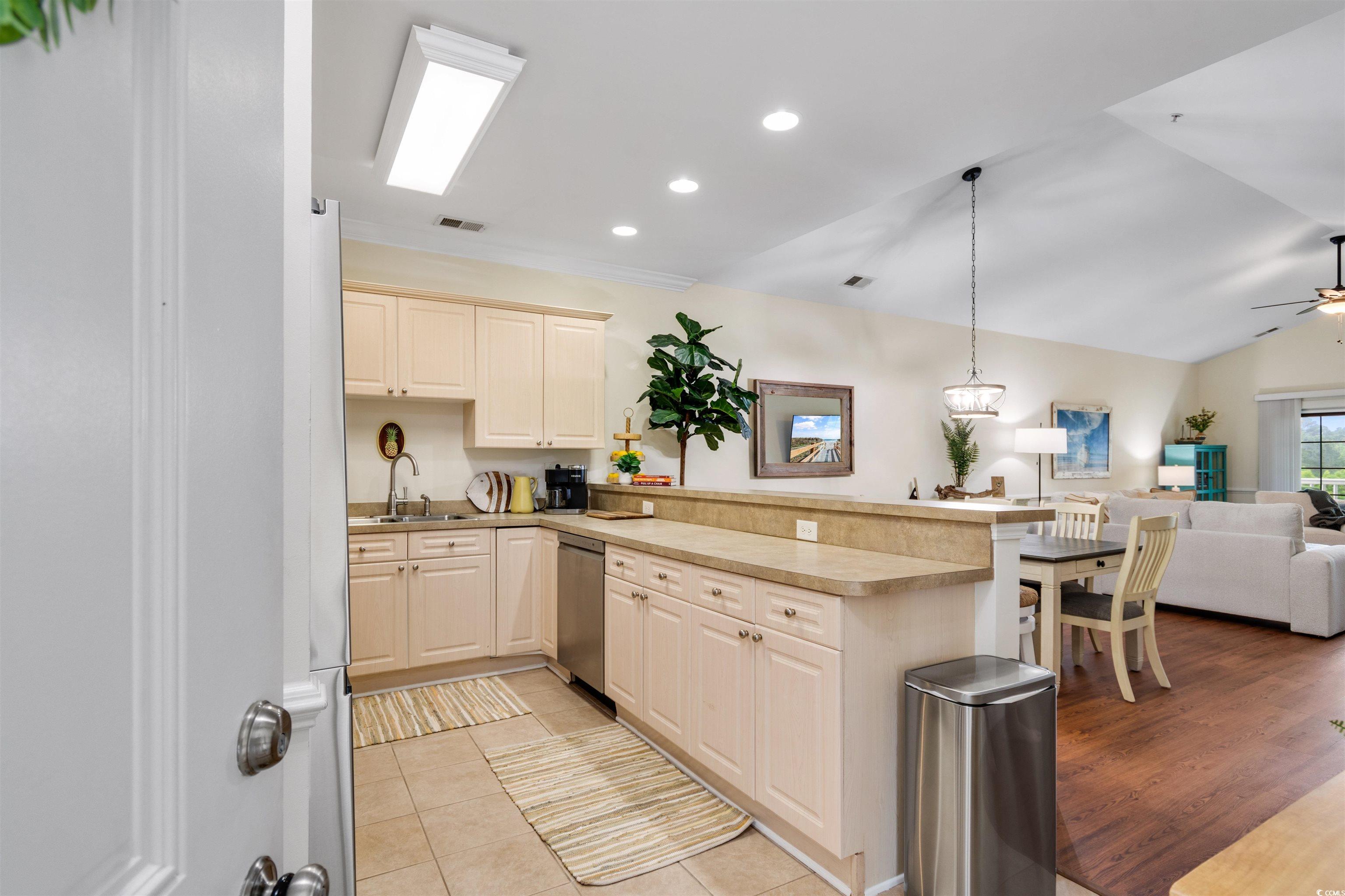 4843 Luster Leaf Circle, Unit 402 Myrtle Beach, SC 29577 - Photo 33 of 33 Kitchen featuring open floor plan, recessed lighting, lofted ceiling, hanging light fixtures, and a peninsula