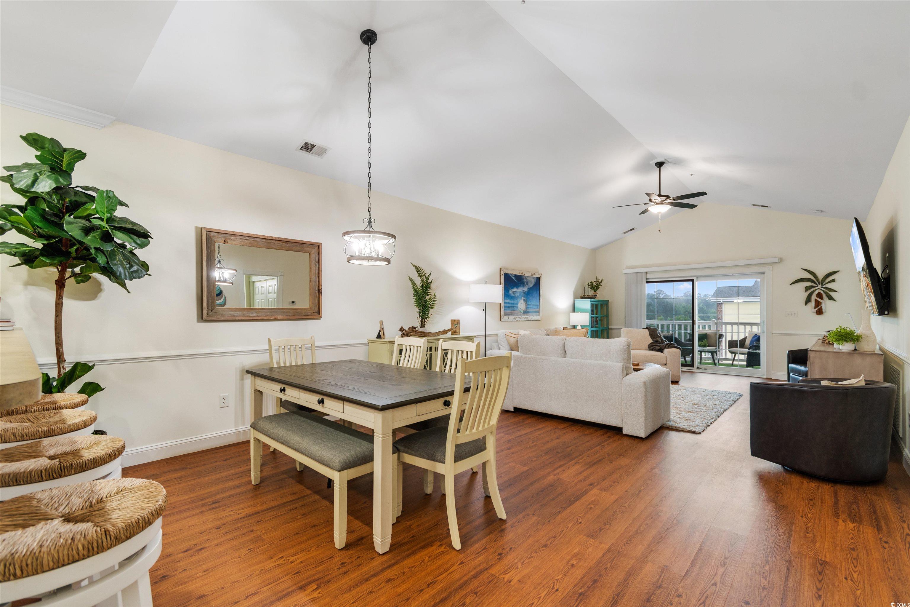 4843 Luster Leaf Circle, Unit 402 Myrtle Beach, SC 29577 - Photo 5 of 33 Dining area featuring vaulted ceiling and wood finished floors