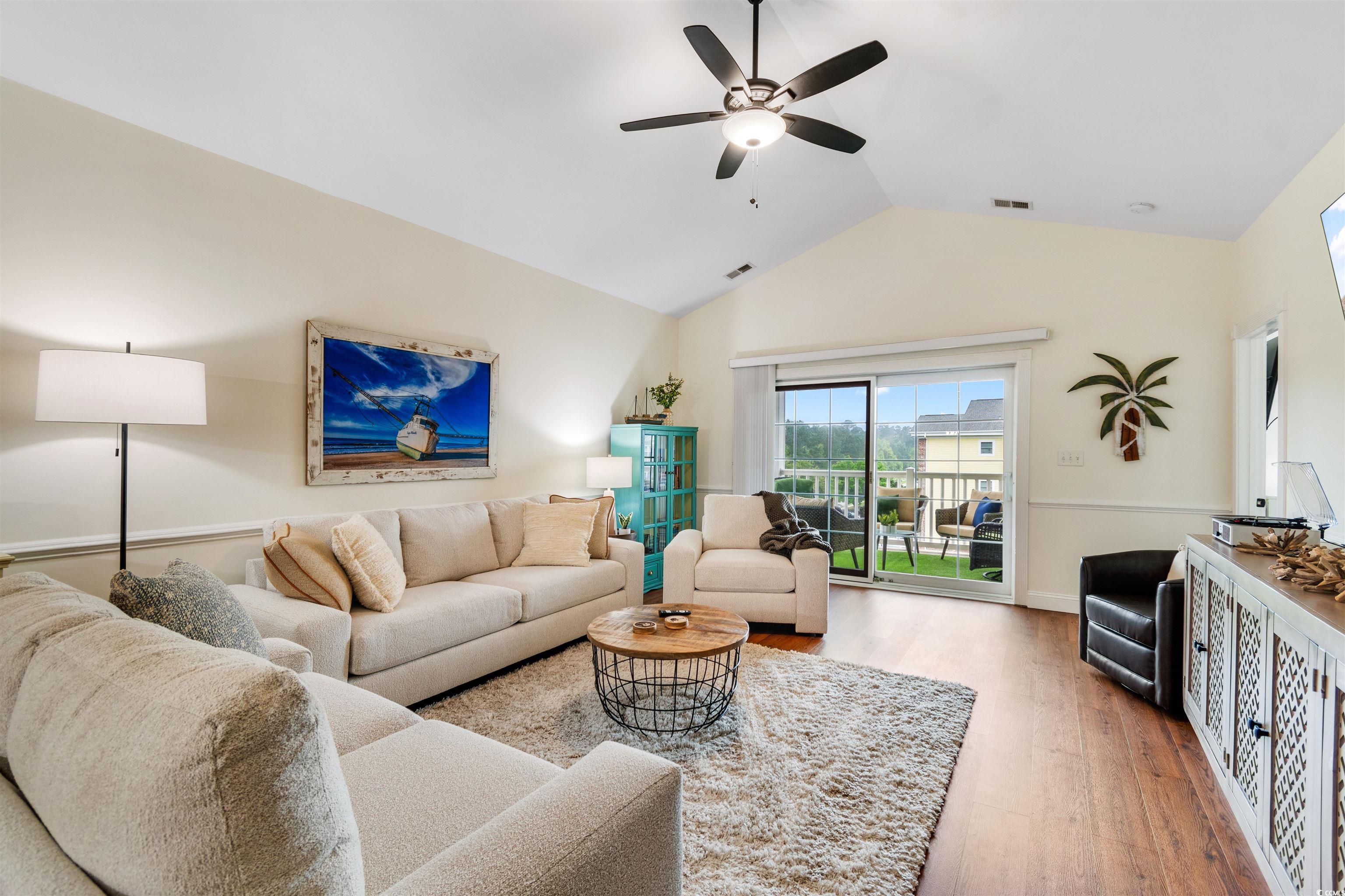 4843 Luster Leaf Circle, Unit 402 Myrtle Beach, SC 29577 - Photo 7 of 33 Living room featuring wood finished floors, a ceiling fan, and high vaulted ceiling