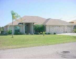 25 Medalist Road Rotonda West, FL 33947 - Photo 1 of 1 a view of a house with a yard and a garden