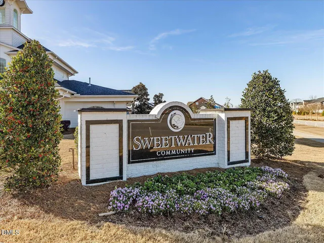 a front view of a residential apartment building with a yard in front of it