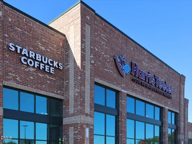 a patio with a table and chairs under an umbrella