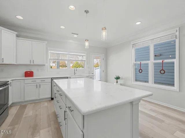 a kitchen with a sink cabinets and window