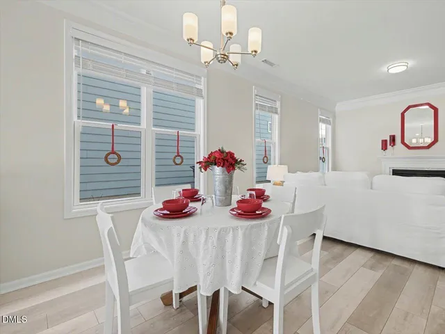 a large kitchen with stainless steel appliances a large counter top and white cabinets
