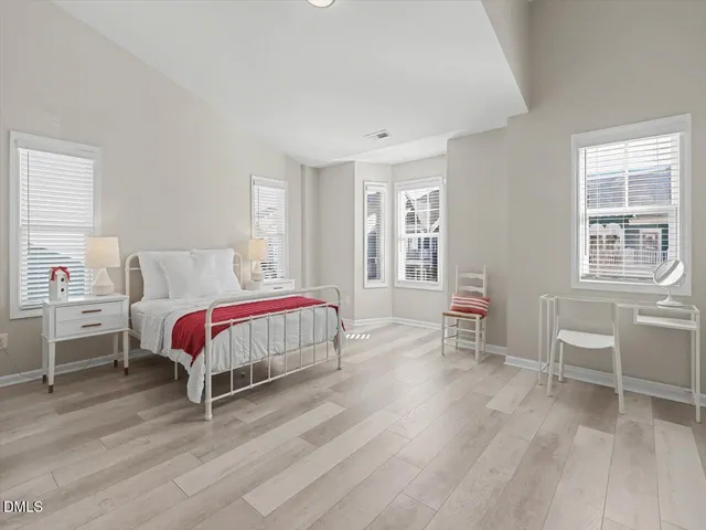 a large kitchen with white cabinets and stainless steel appliances