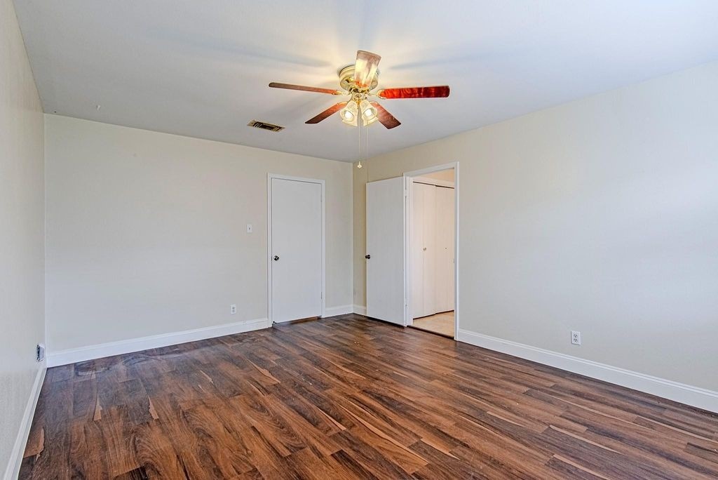 17811 Hawk Haven Lane Spring, TX 77379 - Photo 13 of 22 Primary bedroom with wood flooring, ceiling fan, and a relaxing ambiance.