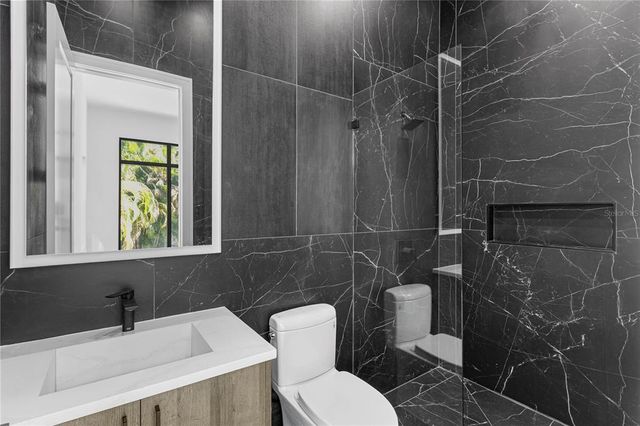 a view of a hallway with wooden walls and a large window