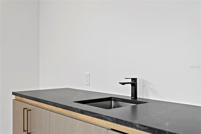 an empty room with a window and a ceiling fan