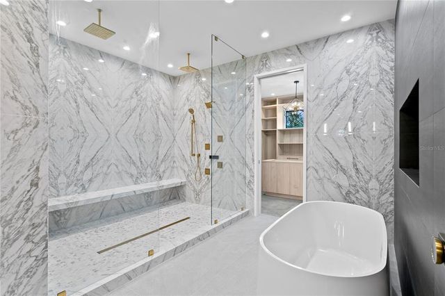 a view of an empty room with closet and a ceiling fan