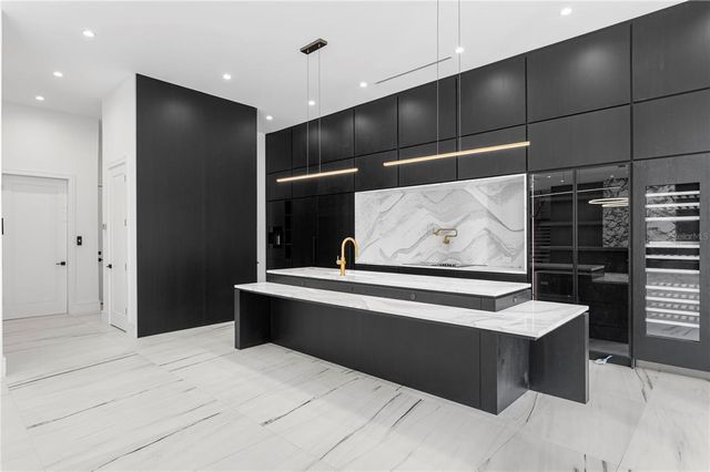 a kitchen with stainless steel appliances granite countertop a refrigerator sink and stove