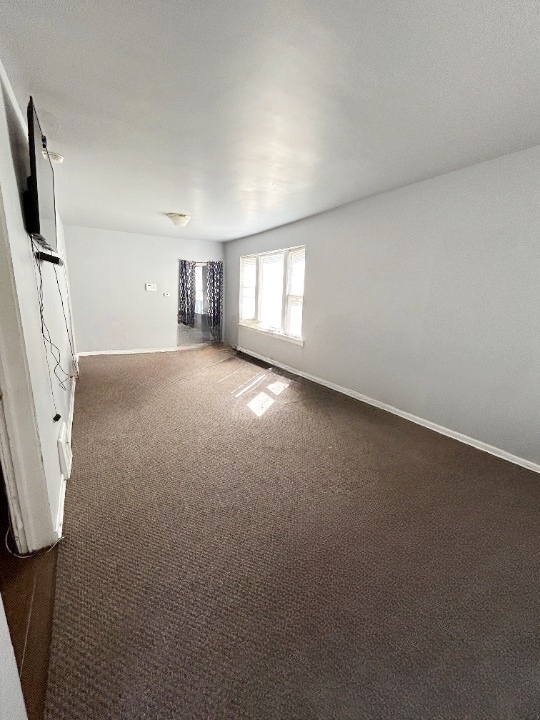 11833 South Perry Avenue Chicago, IL 60628 - Photo 2 of 8 an empty room with windows