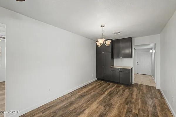 a kitchen with stainless steel appliances granite countertop a refrigerator a sink dishwasher a stove and a oven with wooden floor