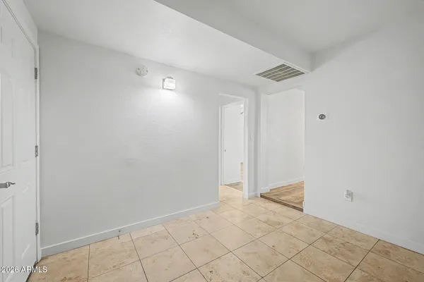 an empty room with a window and a ceiling fan