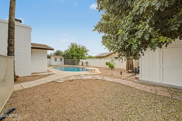 a view of a swimming pool with a yard