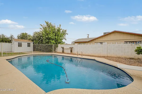 a view of a backyard with wooden fence