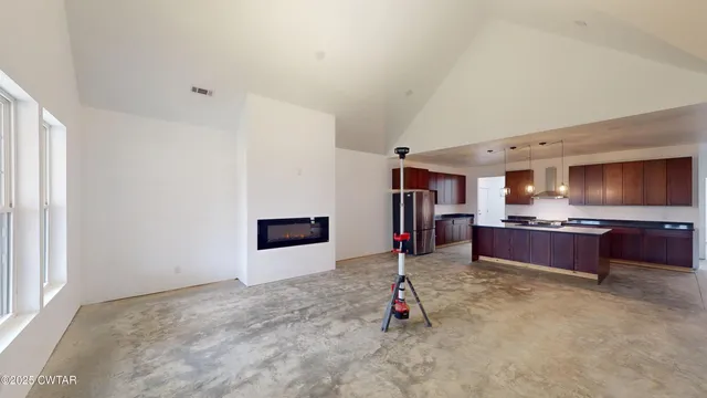 a kitchen with stainless steel appliances granite countertop a sink a stove and a refrigerator
