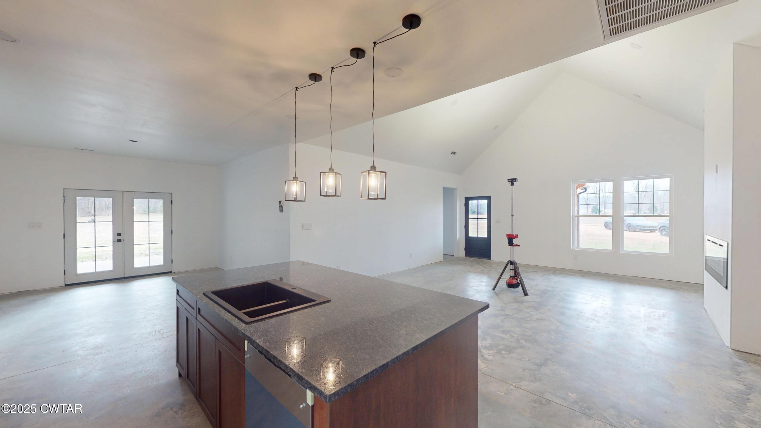 3140 Rowland Mill Road Buena Vista, TN 38318 - Photo 9 of 34 a view of a kitchen and a sink wooden floor windows and a chandelier