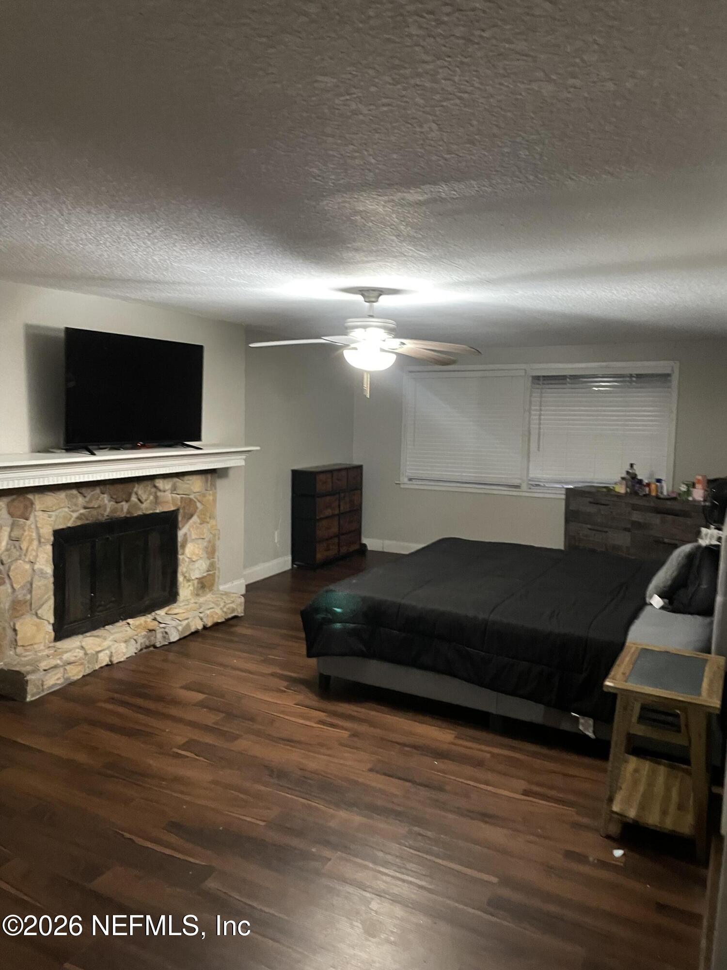 5884 Retha Road Jacksonville, FL 32254 - Photo 14 of 16 a living room with furniture a fireplace and a flat screen tv