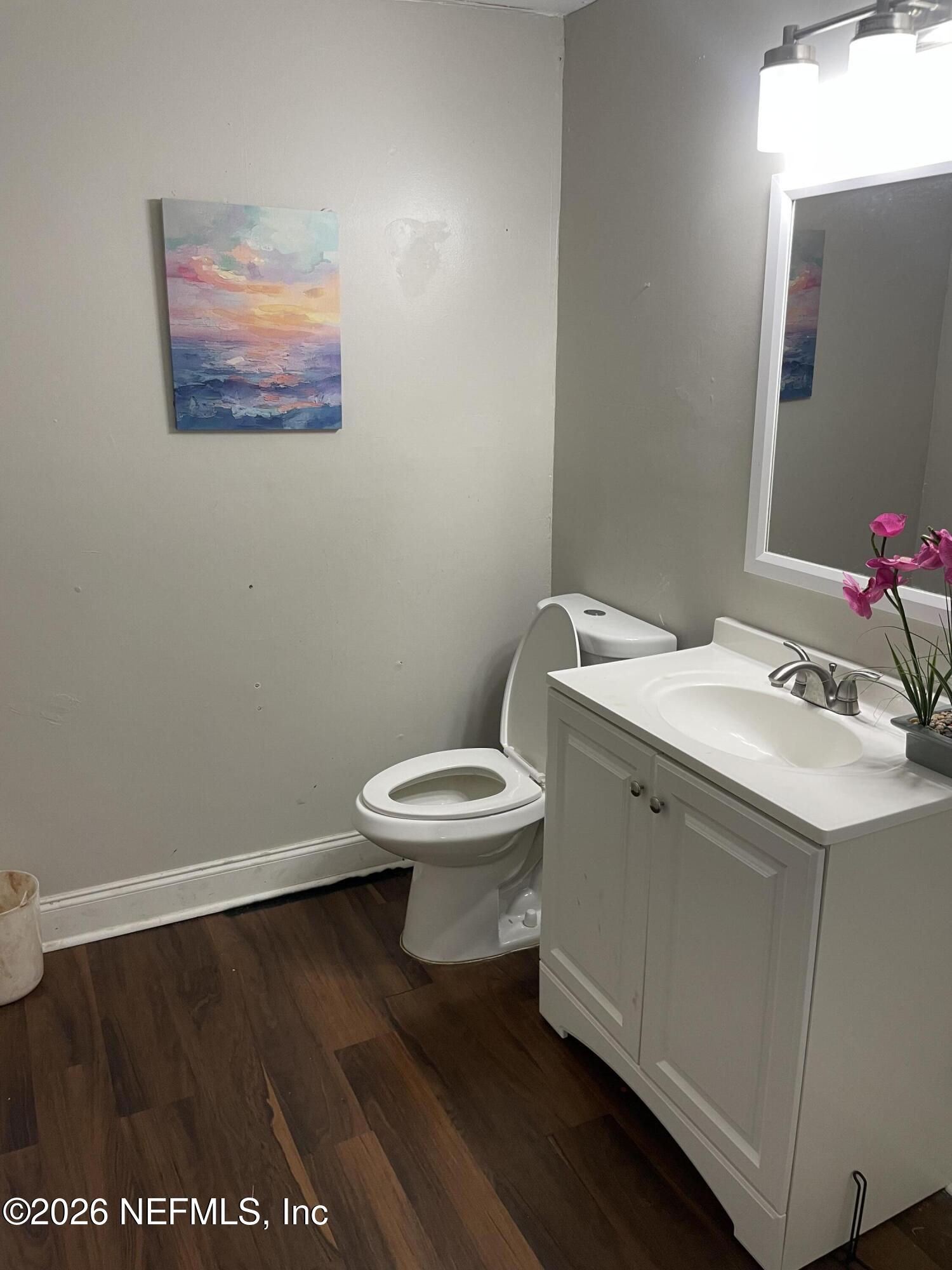 5884 Retha Road Jacksonville, FL 32254 - Photo 15 of 16 a bathroom with a toilet sink and mirror
