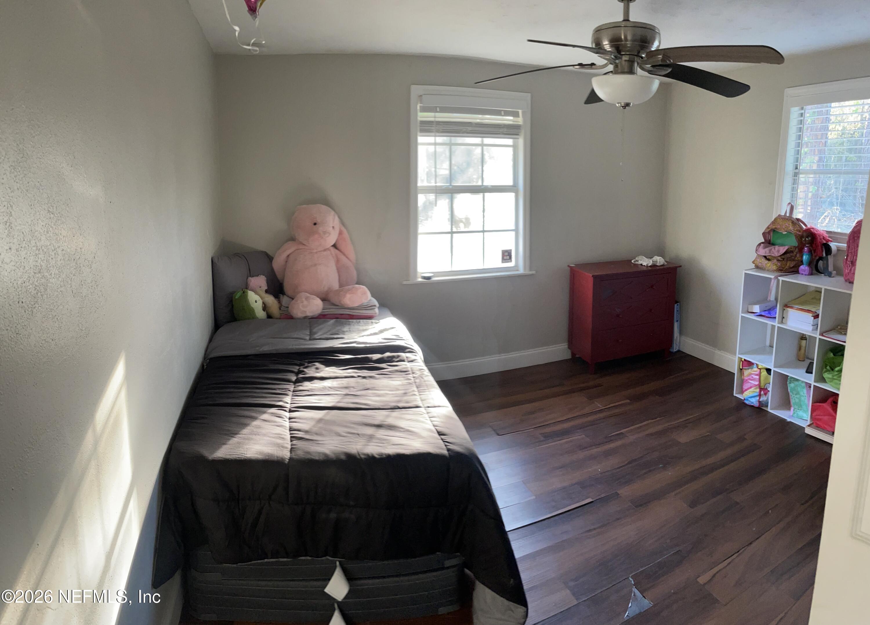 5884 Retha Road Jacksonville, FL 32254 - Photo 5 of 16 a bedroom with a bed and wooden floor