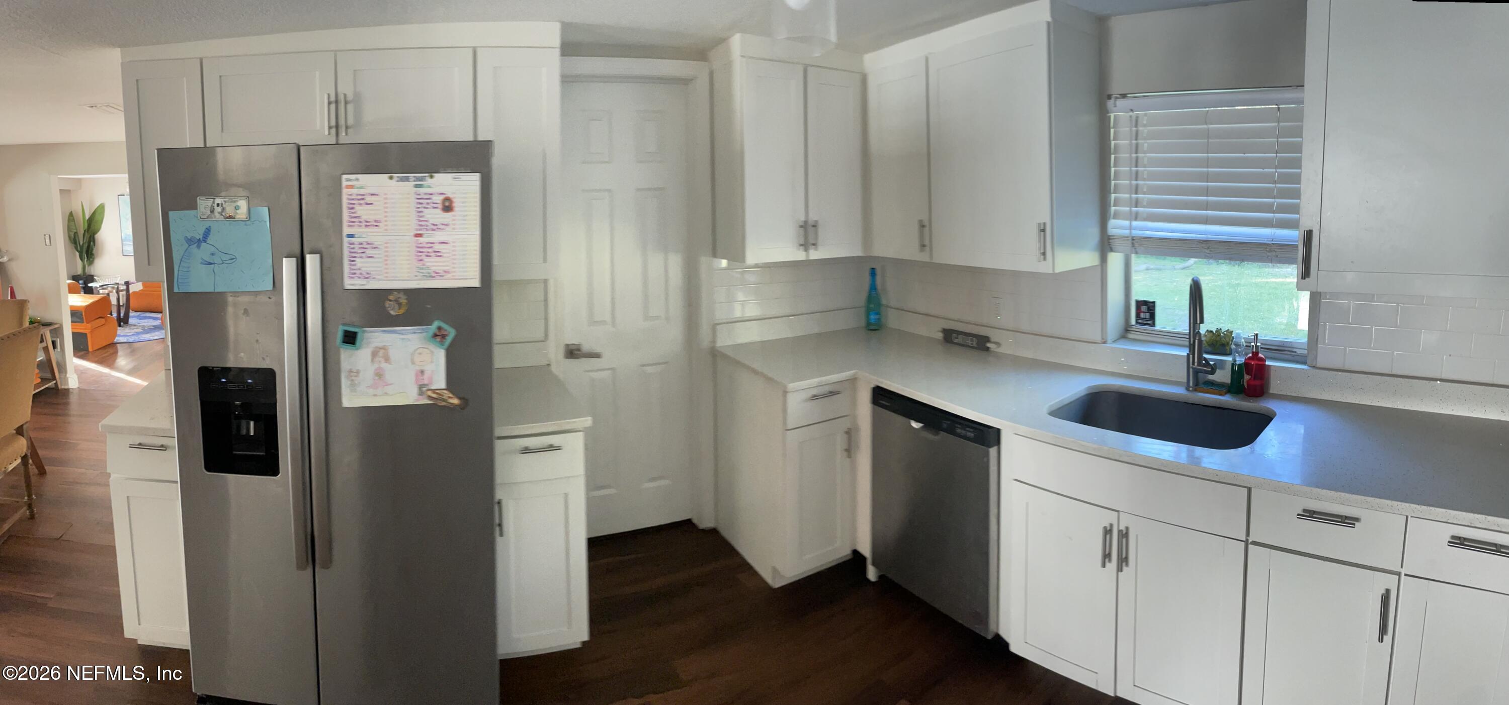 5884 Retha Road Jacksonville, FL 32254 - Photo 7 of 16 a kitchen with stainless steel appliances a sink cabinets and a window