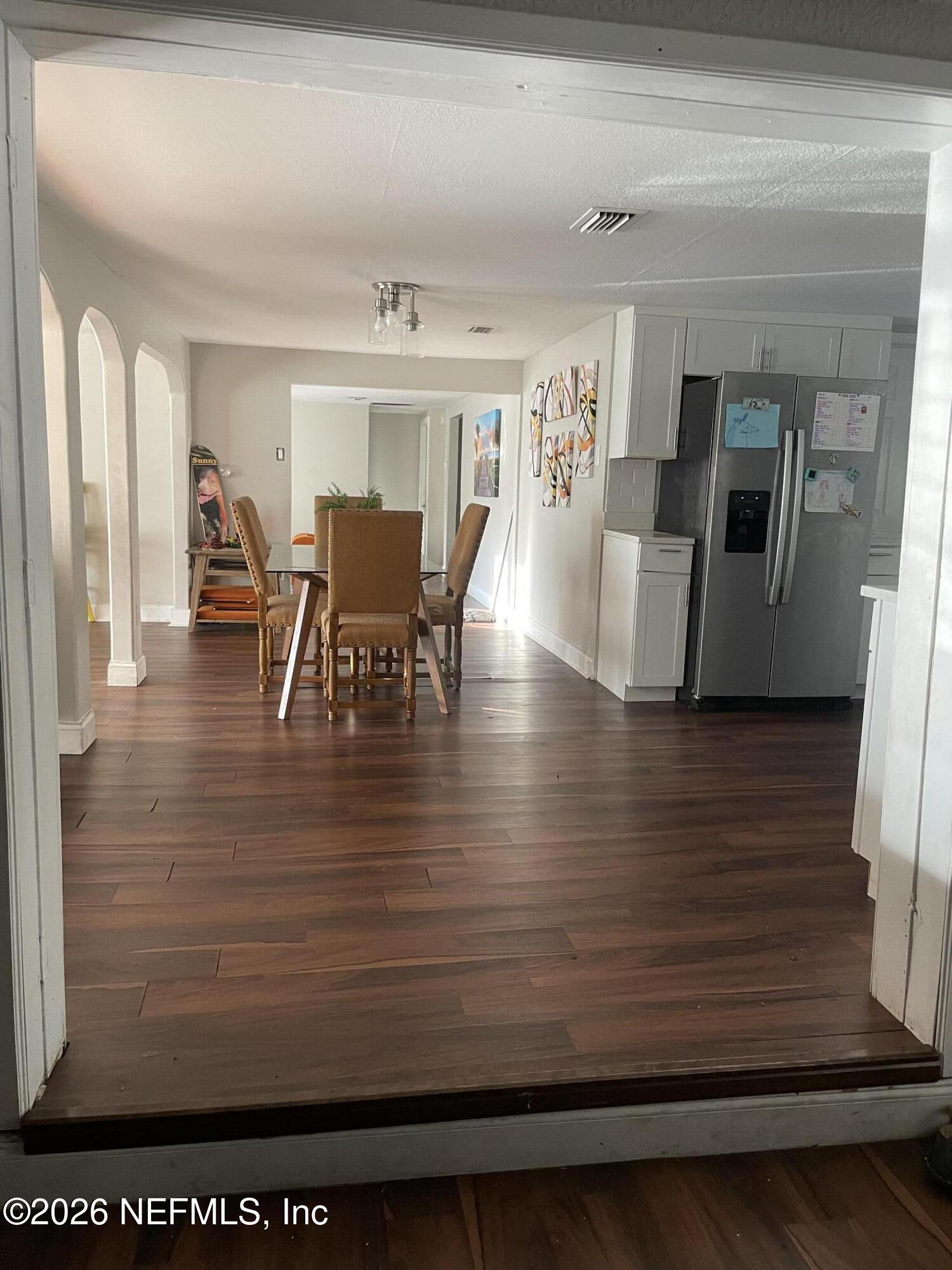 5884 Retha Road Jacksonville, FL 32254 - Photo 8 of 16 a view of a dining room with furniture and wooden floor